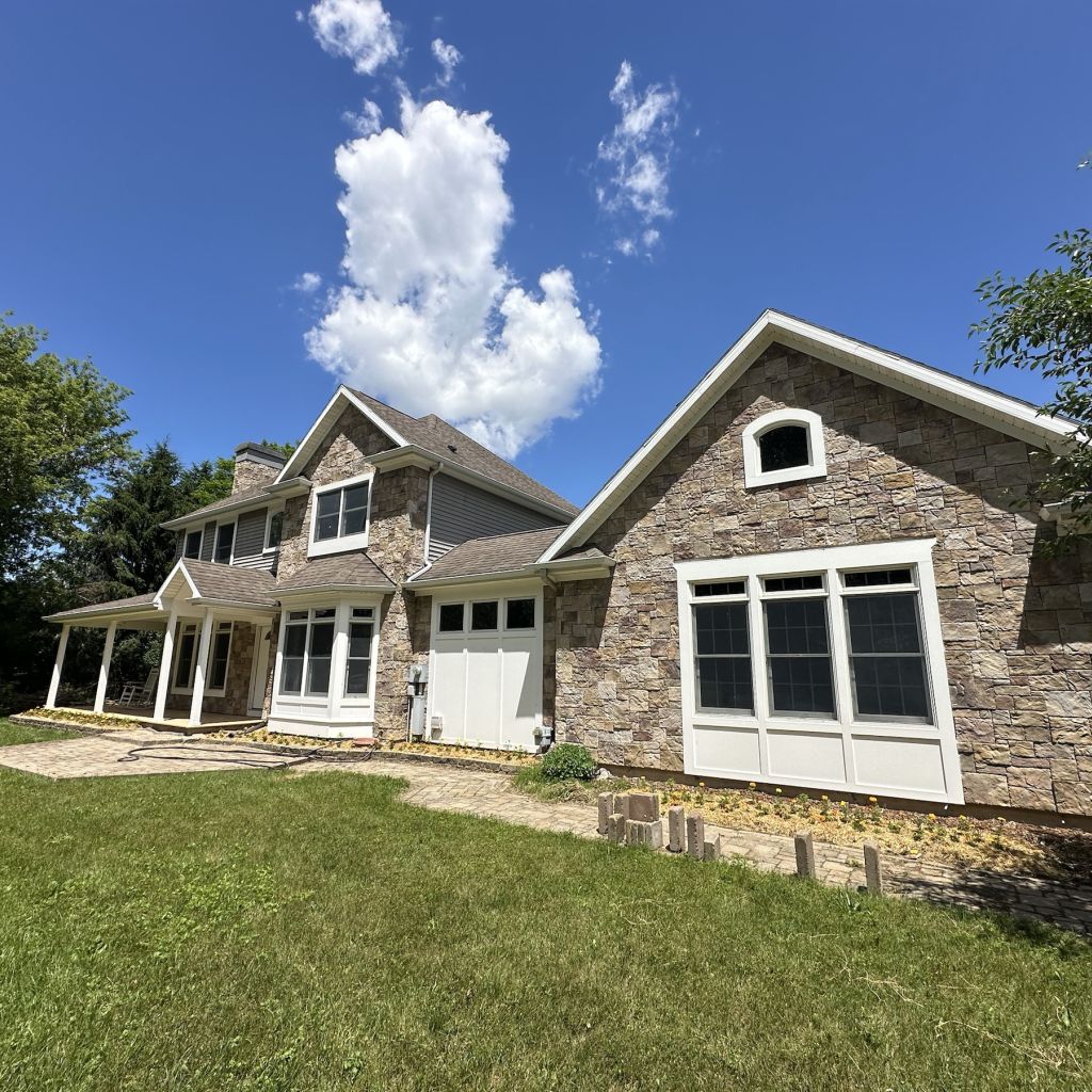 Completed home exterior project with a bright window-filled living area
